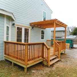 a wood deck and patio cover for a residential home
