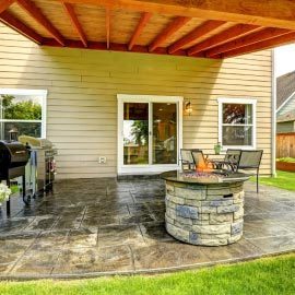 a wood patio cover for a backyard cement outdoor space
