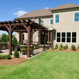 a stylish dark wood pergola for a home backyard