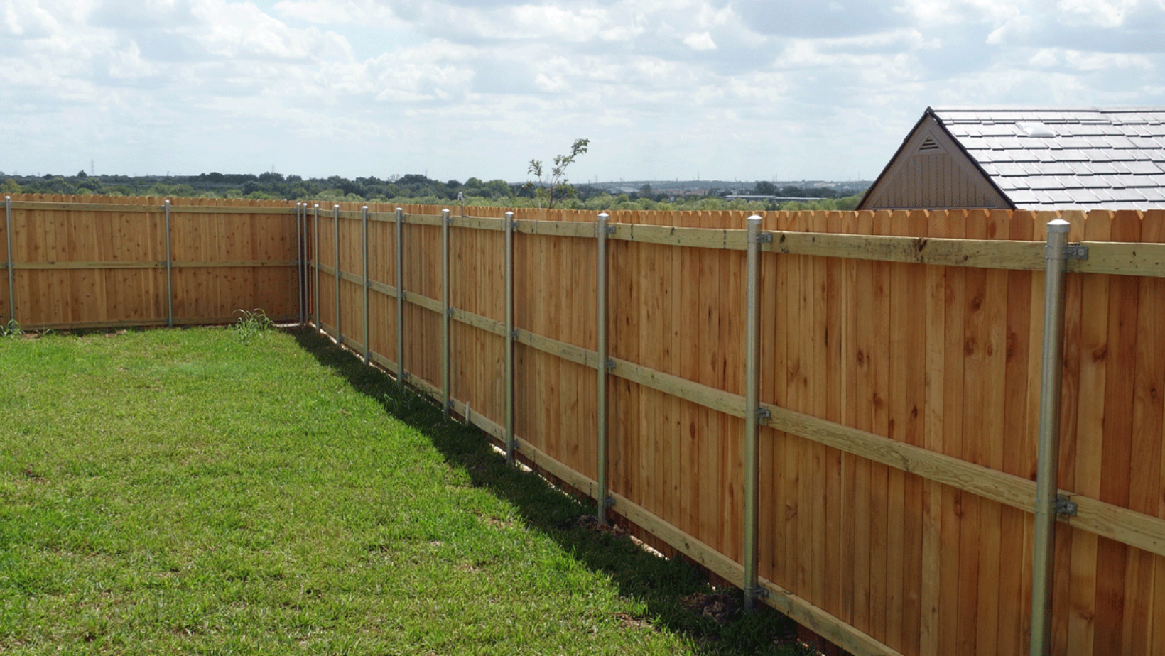 wood-fence-blue-sky-green-grass