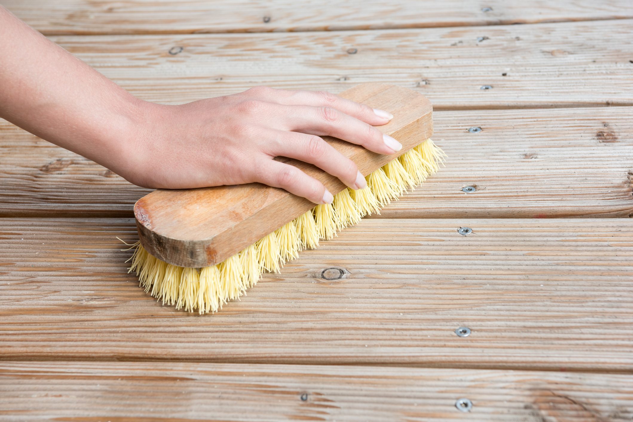woman scrubbing wood floor
